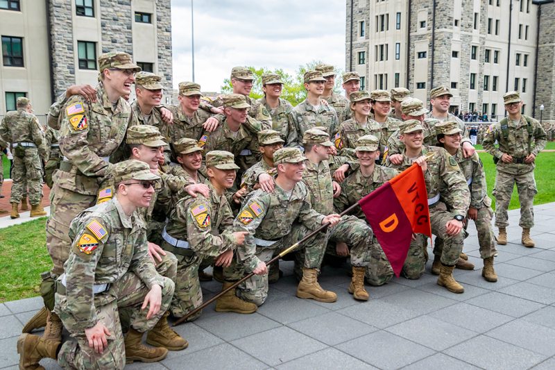 Three cadets fold an American flag.