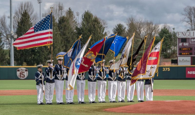 The Corps of Cadets' Color Guard carry the flags on English Field before a baseball game.