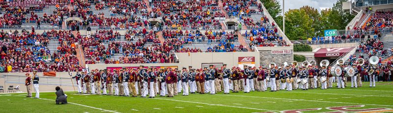 The Highty-Tighties and the Highty-Tighty alumni perform during the annual Corps Homecoming football game in Lane Stadium.